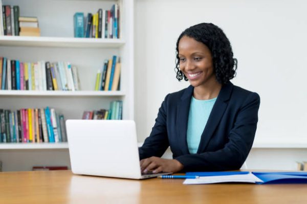 Pretty african american businesswoman working at computer at homeoffice to stay at home